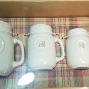 4 measuring cups filled with kiss, hugs, love, joy